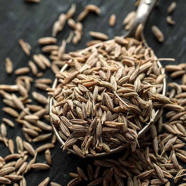 Fresh Indian cumin seeds arranged in a bowl.
